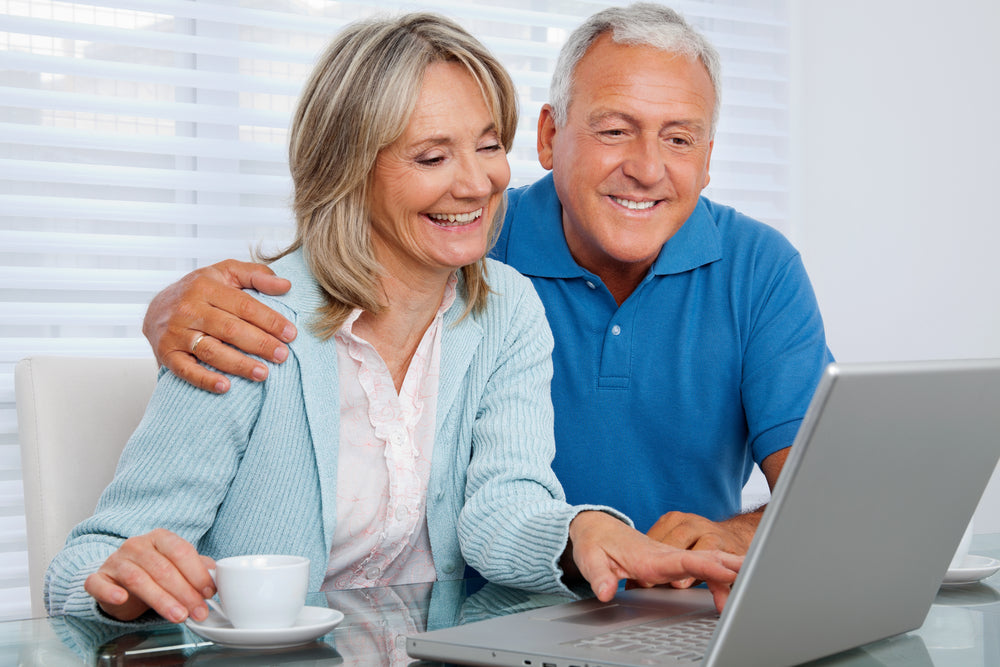 two people sitting next to computer booking mortgage appointment